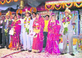 Newly wed couples take a vow against female foeticide at a mass marriage sammelan in Rewari