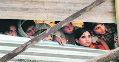 Villagers watch an encounter unfold in Warpora village, north of Srinagar