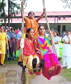 Young girls enjoy a swing ride on the occasion of Teej organised at Cyp Asia Centre in Sector 12, Chandigarh