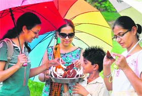 Young girls enjoy coconut in rain-soaked Chandigarh