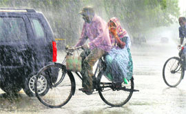A couple caught in rain at the press light point in Sector 18, Chandigarh, on Sunday.