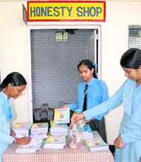 Students buy notebooks from the Honesty Shop
