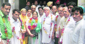 Newly elected president (green suit with spectacles) of the municipal council, Ahmedgarh, flanked by supporting councillors at Town Hall, Ahmedgarh, on Wednesday.