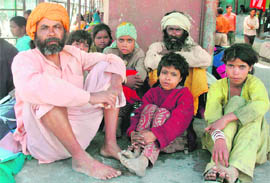 Family members of labourers from Bihar huddle at a bus stop at Batmaloo after a grenade explosion killed five persons on Thursday.