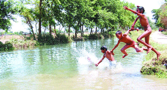 Kids take a plunge into a canal to beat the blistering heat in Amritsar