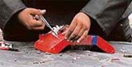 A member of the bomb disposal squad defuses a bomb found in a rubbish container in Ahmedabad on Sunday.