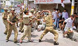 Policemen lathicharge protesters after a demonstration turned violent during the Jammu bandh on Sunday.