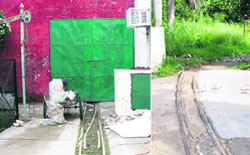 A view of the garage where the toy train is locked up due to lack of maintenance and driver for the past four years. The rail track (R) is in a poor condition due to wild grass at Indira Holiday Home in Sector 24, Chandigarh