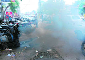 Thick smoke emanates from a generator set used by a bank in a market near the main bus stand in Karnal.