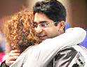 Abhinav Bindra is hugged by his coach Gabriele Buhlmann after shooting in the finals of the men's 10m air rifle competition