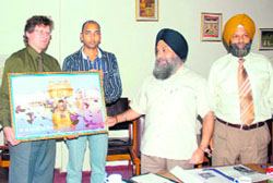 Vice-chancellor of Punjabi University, Dr Jaspal Singh (centre), presents a picture of Golden Temple to Siguard Meldal, head, department of computer engineering, San Jose State University, during an education exchange programme at Punjabi University, Patiala, on Monday.