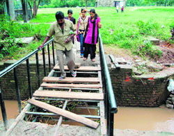 Visitors at Leisure Valley, Sector 10, Chandigarh, walk on the bridge despite the missing slippers which can prove fatal.