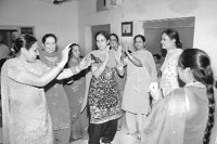 Women perform giddha while celebrating Teej.