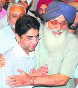 Punjab Chief Minister Parkash Singh Badal hugs Abhinav Bindra at a state function in Chandigarh on Monday.