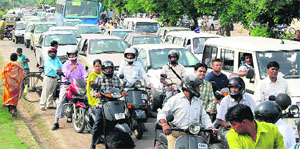 People stranded at a road of Sector 8 in Panchkula as the police blocks majority of roads in the city to conduct marathon and rallies on Rajiv Gandhi Akshay Urja Divas celebrated on Wednesday.
