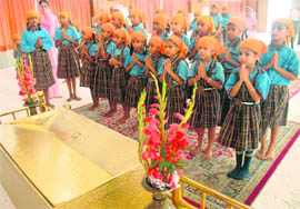 Schoolchildren pray for Indian boxer Vijender Kumar’s victory at the Olympics, in a gurdwara in Sector 8, Chandigarh, on Friday.