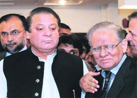 Nawaz Sharif and his party candidate for the upcoming presidential election Saeed- uz-Zaman Siddiqui (right) before a press conference in Islamabad