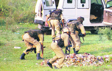 Security personnel take up positions during the encounter in the Chinore area of Jammu on Wednesday.