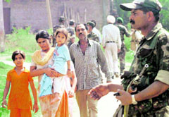 A family rescued from militants clutches in Chinore on the outskirts of Jammu on Wednesday.