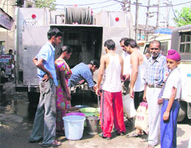 Residents of Daresi fetch water from a tanker in Ludhiana on Thursday.