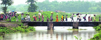 Flood-hit move to safer places in Madhepura on Friday.