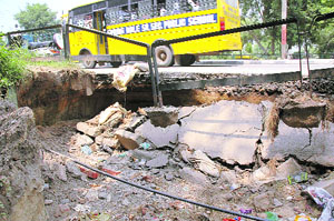 DEATH TRAP: A part of the Sherpur road has caved in, posing a threat to commuters.