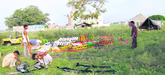 Workers set up a fixture at the venue of Chhapar Mela near Ahmedgarh.