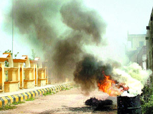 A scrap dealer burns wires to collect copper right in the middle of the street in Butan Mandi in Jalandhar.