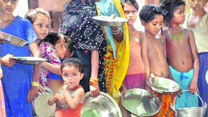 Flood victims await relief in Bihars Farbisganj on Friday.