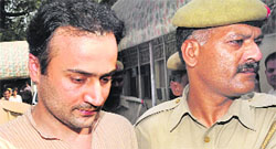 Sanjeev Nanda being taken away by police.
