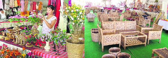A stall owner decorates flowers in a vase made of cane; and (right) products on display at the North East Craft Fair in Ludhiana.
