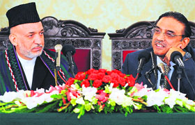 Pakistans new President Asif Ali Zardari with Afghan President Hamid Karzai by his side in his maiden news conference in Islamabad on Tuesday