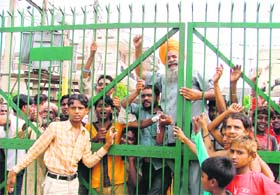 Residents of Dr Ambedkar Nagar protest against locking of a gate by residents of C block in Model Town Extension