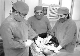 Dr Balbir Kumar (left) performs surgery at civil hospital Garhshankar