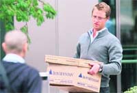 A man carries a box after leaving the Lehman Brothers European headquarters building in Canary Wharf in east London on Monday.