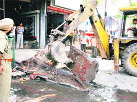 The Municipal Corporation during a demolition drive at Ferozepore road in Ludhiana on Monday.