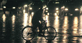 A man caught in the sudden rain as he crosses the roundabout in Sector 26 in Chandigarh on Wednesday.