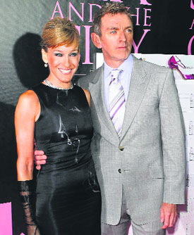 Actor Kim Cattrall lets her hair down. Actor Sarah Jessica Parker arrives with Michael Patrick King for the DVD launch event for "Sex and the City: The Movie" in New York on Thursday.