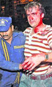 A security guard helps a foreign guest leave the building after the explosion.