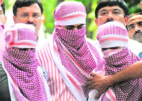 Their faces covered, three suspected militants, Shakir Nishar, Zia-Ur-Rehman and Shakil, involved in last week's serial blasts in New Delhi