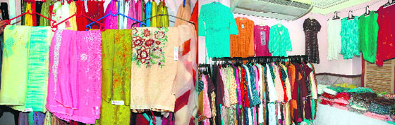An exhibition of shadow work suits (left) and traditional Rajasthani cotton fabrics on display at Hotel Aroma.