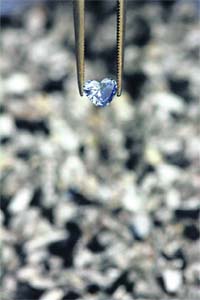 An Algordanza employee shows an example of a diamond next to ashes in Chur, Switzerland