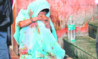 A relative of Santosh, 13, who was killed in the bomb blast in Mehrauli, outside the trauma centre at the All-India Institute of Medical Sciences in New Delhi