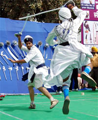 Participants showcase their skills during a gatka contest in Amritsar on Tuesday.