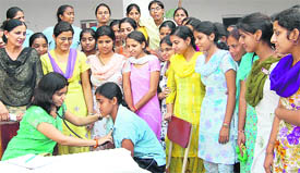 Girls being examined at a medical check-up camp organised at Ramgarhia Girls College in Ludhiana on Tuesday.