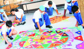 Students of Jesus Sacred Heart School take part in rangoli competition in Ludhiana on Tuesday.