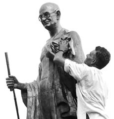 A municipal corporation worker washes the statue of Mahatma Gandhi on the eve of his birth anniversary in Patiala on Wednesday.