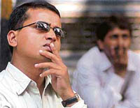 Dejected investors look at the BSE ticker in Mumbai on Monday.