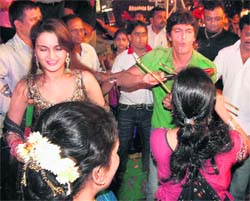 Bollywood actors Chunkey Pandey and Monica Bedi play dandiya at the Sankalp Mitra Mandal in Thane on Saturday