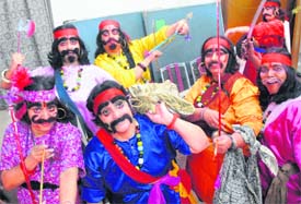 Cosmetic change: Young girls get a makeover to play the part of dacoits in a skit at Banga Bhavan-35 as part of the Durga Puja festivities